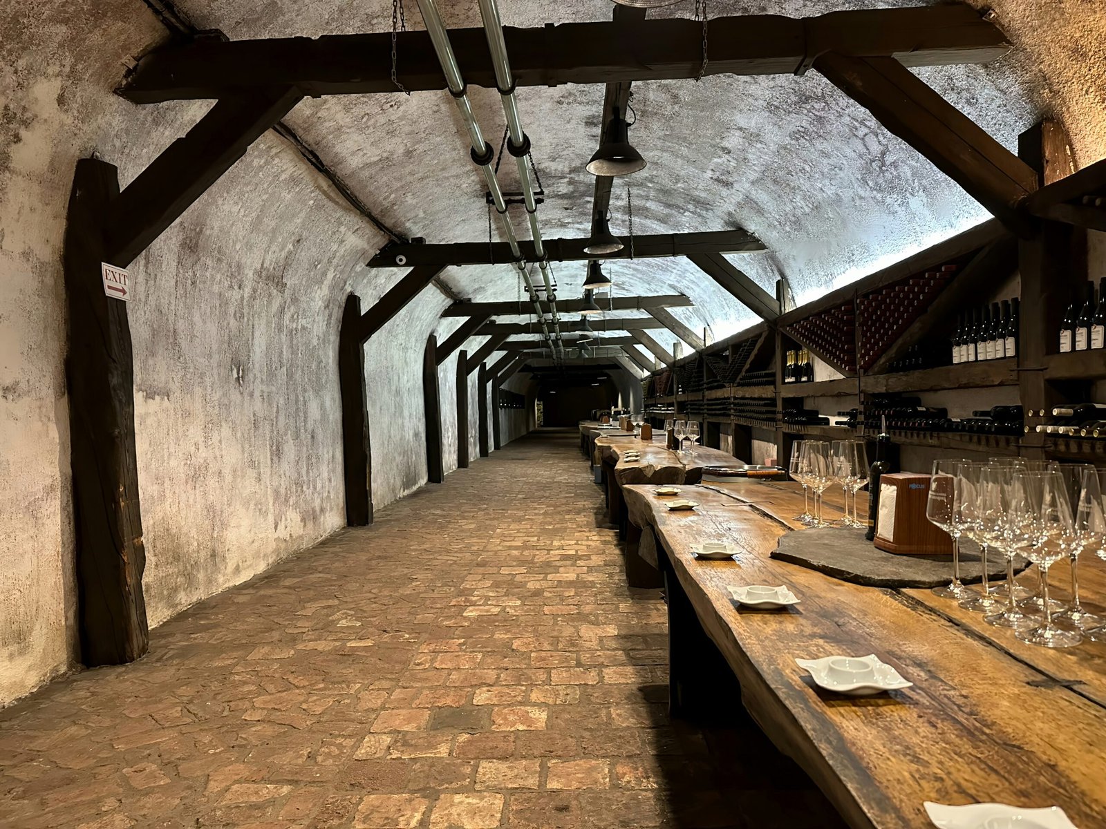 a row of wine glasses sitting on top of a wooden table